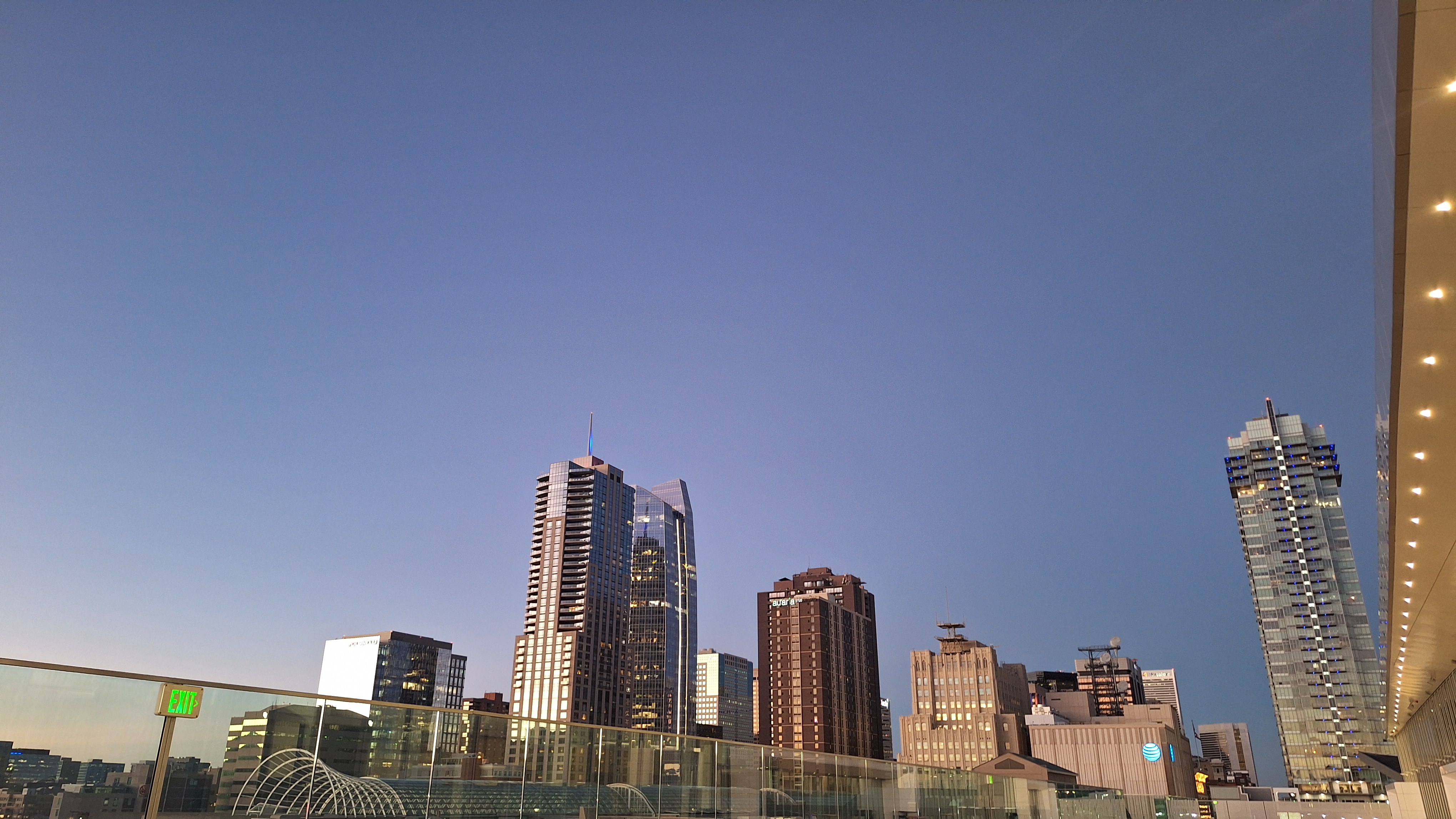 The feverish yellow-white fluorescent emanating from the few office lights in the high-rises.
